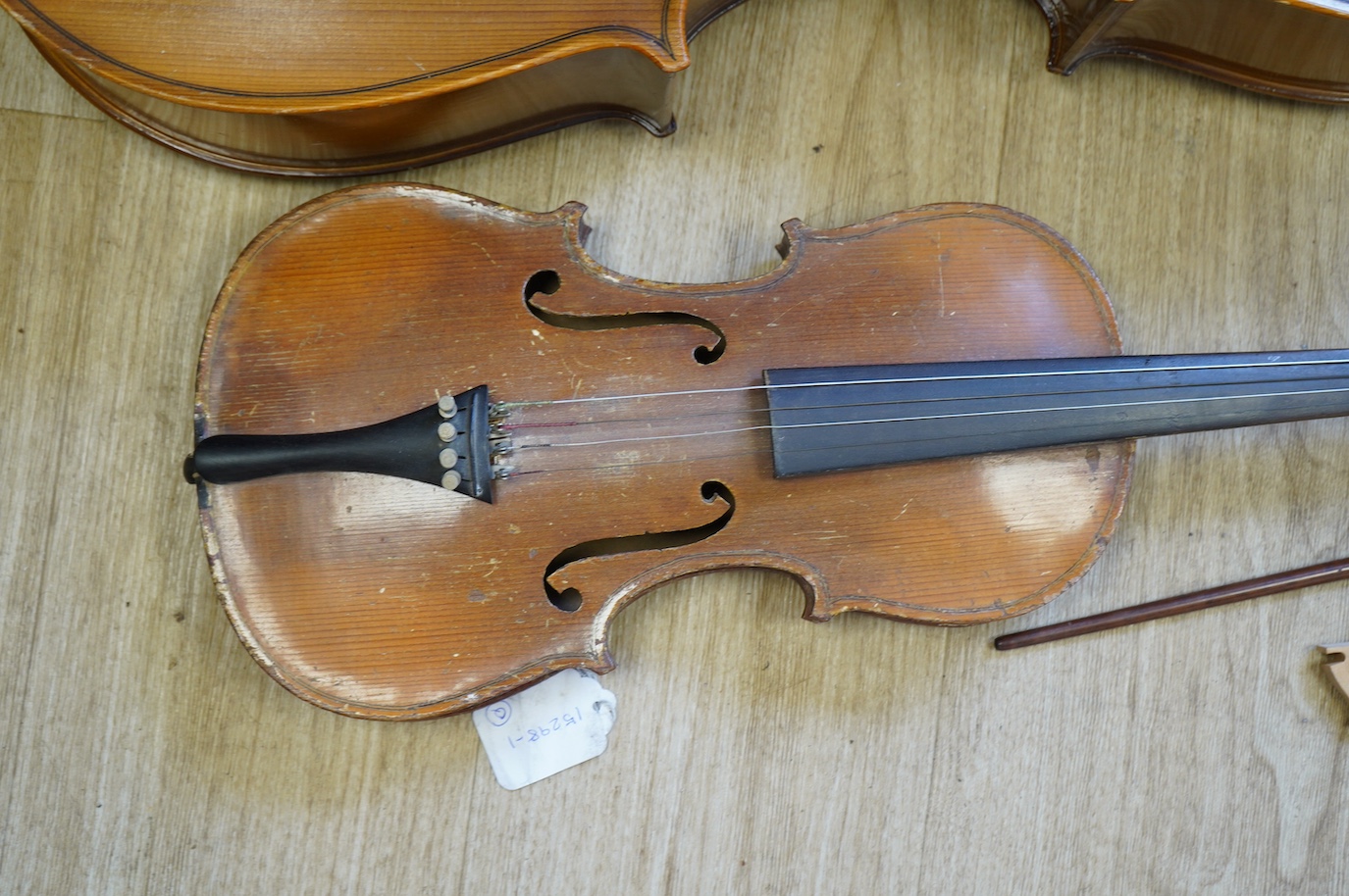 A student’s Golden Strad ‘cello imported by Boosey and Hawkes, body 69.5cm and violin, body 36cm, and a wooden conductors baton. Condition - poor to fair